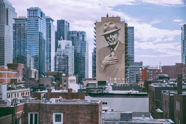 Montreal's skyline with the downtown skyscrapers and the Leonard Cohen homage mural
